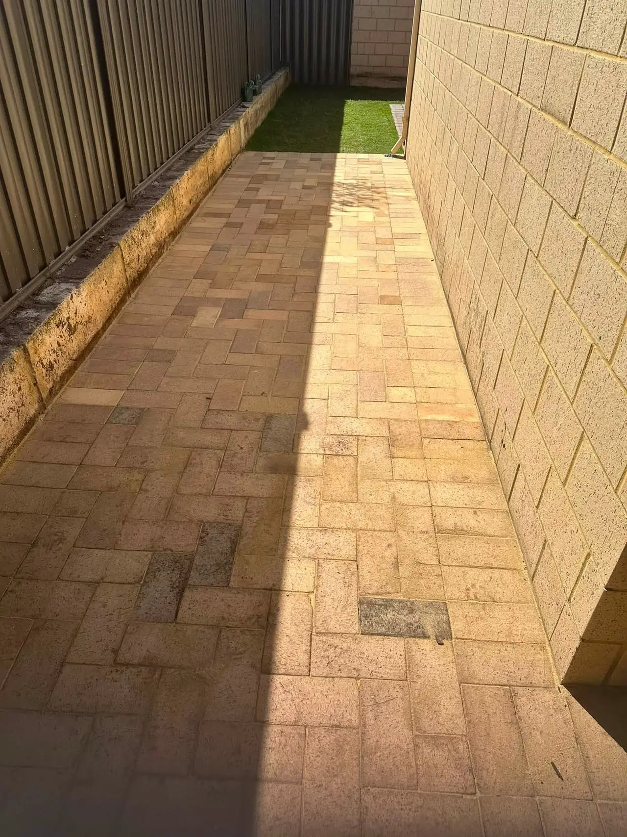 New brick paving laid wall to fence down a side path in Brabham