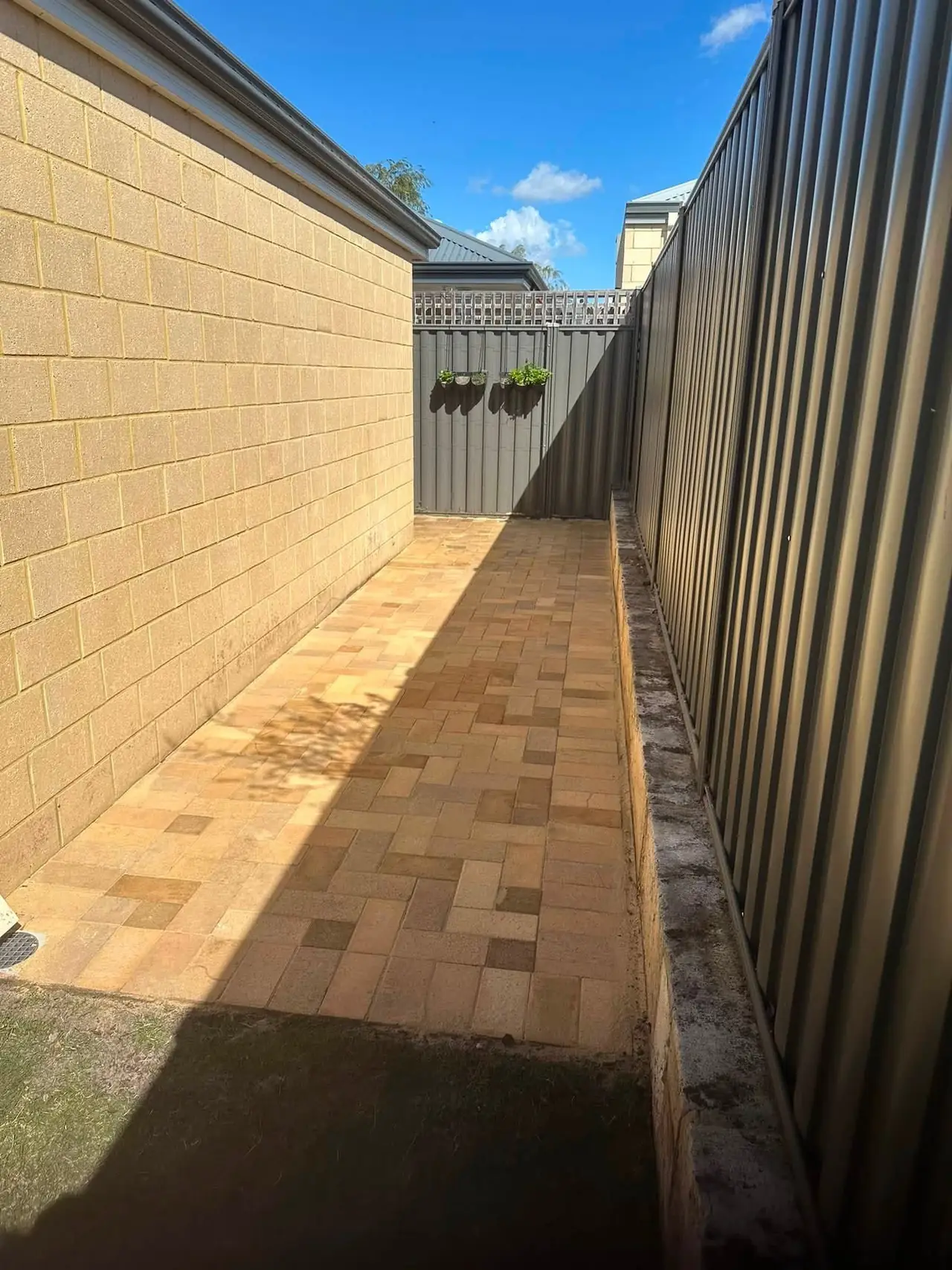 Finished Brabham side path paving looking back toward the gate