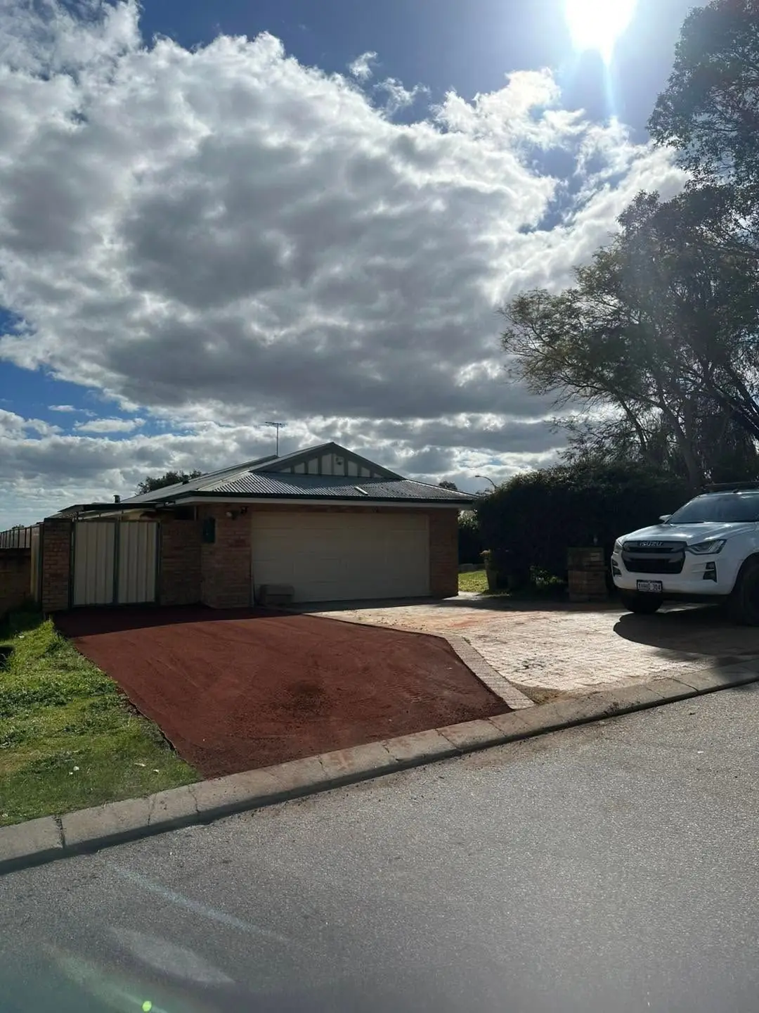 Red road gravel hardstand, finished and compacted, seen from the street