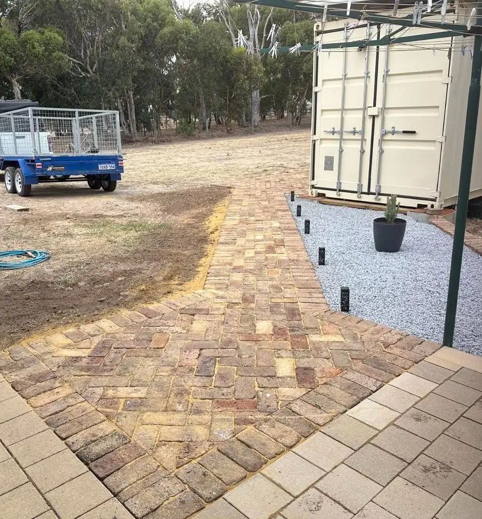 45 degree herringbone brick paving leading up to a shed